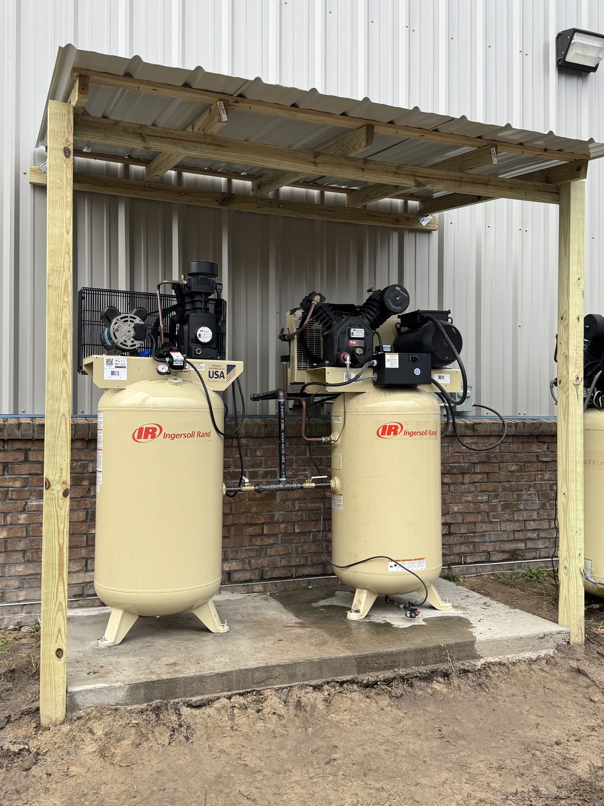 Compressed air equipment installed under an outdoor canopy at a Sumter area facility