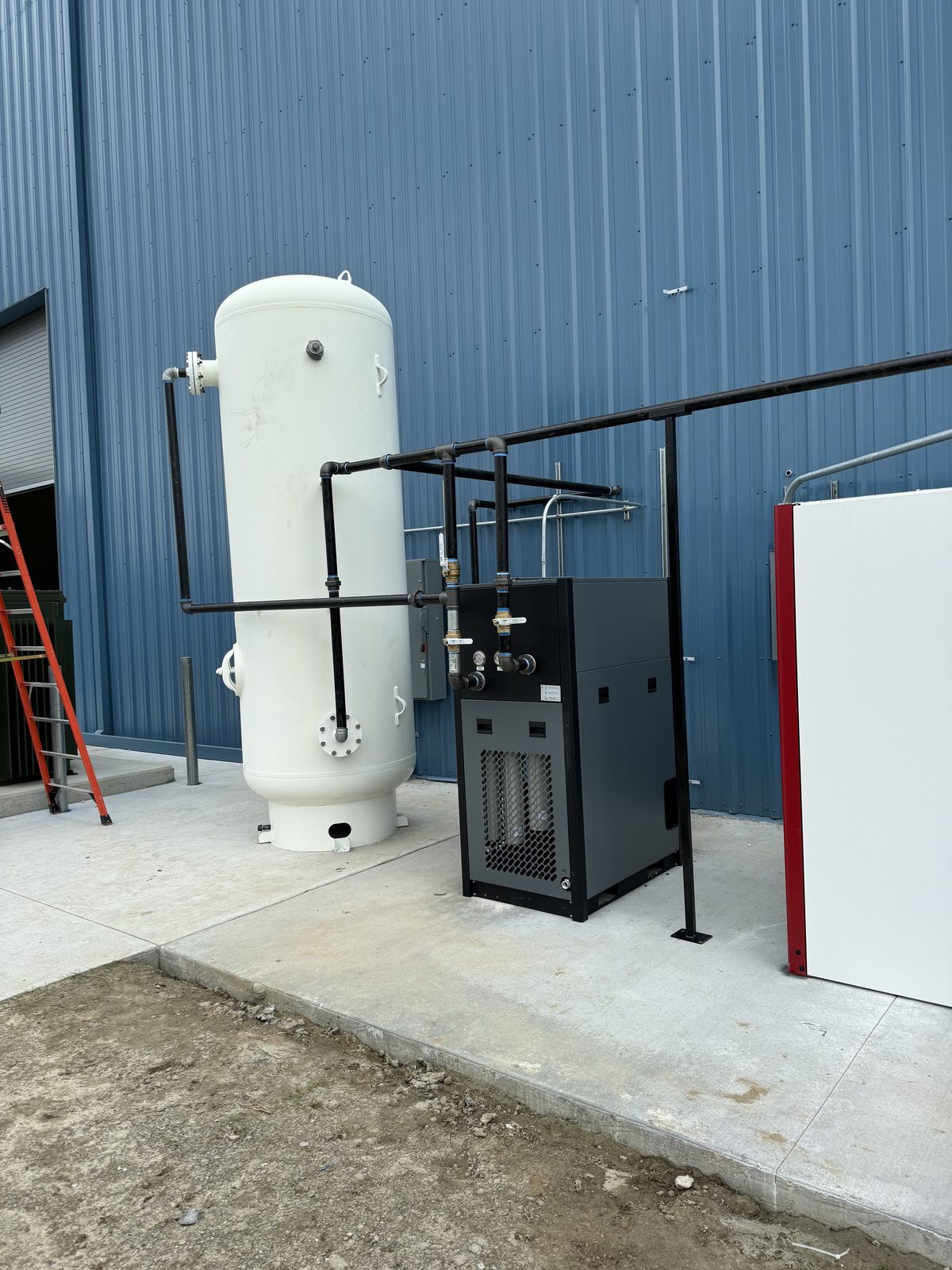 Exterior wall-mounted compressed air retrofit with receiver and dryer