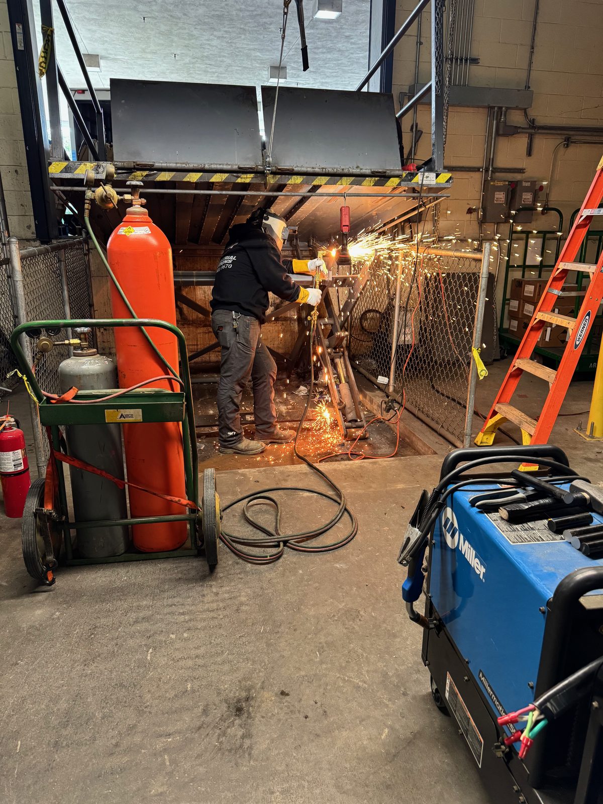 Technician working on industrial equipment during an after-hours emergency call