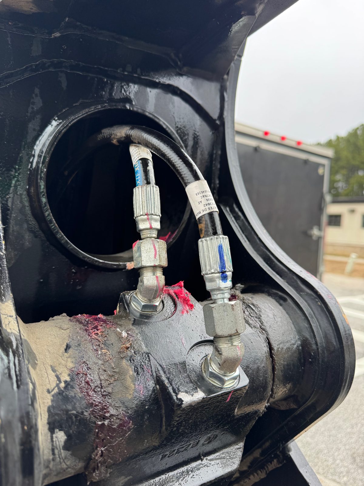 Hydraulic fittings and lines on an industrial cylinder
