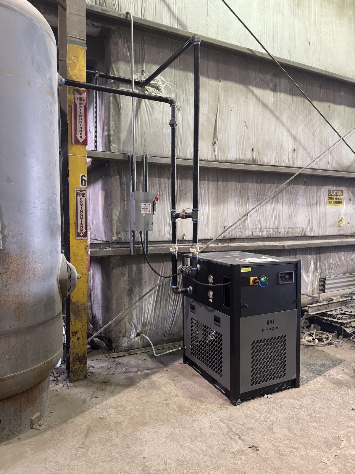 Compressed air lines and electrical conduit installed together through a facility
