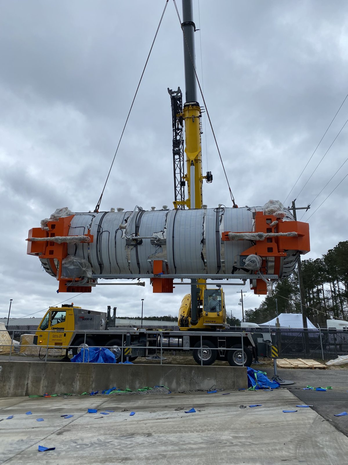 Crane lifting a large industrial vessel into position during an equipment installation