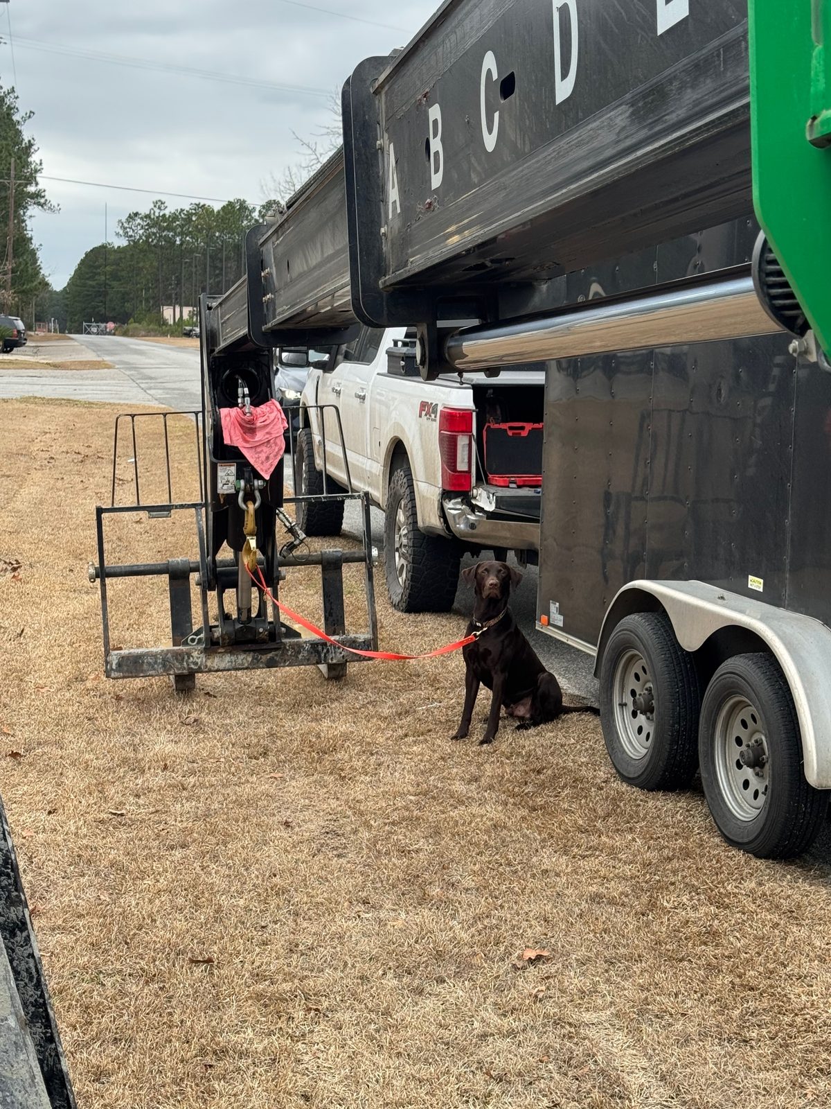 Service truck and equipment trailer at a job site